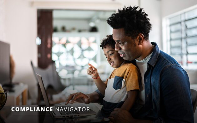 father and son looking at computer