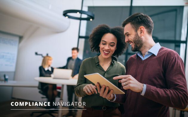 Two people in business attire, smiling, holding a tablet. Compliance Navigator