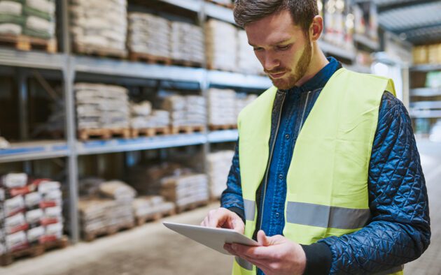 Warehouse employee looking at tablet