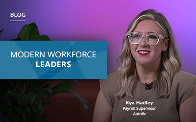 Woman with glasses and long hair sits in front of a purple backdrop next to text that reads "Modern Workforce Leaders.