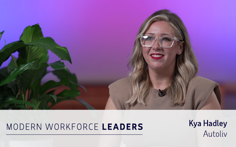 A woman with blonde hair and glasses sits indoors, smiling. Text overlay reads "Modern Workforce Leaders" and "Kya Hadley, Autoliv.
