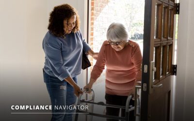 A woman assists an elderly woman using a walker as they enter a doorway.