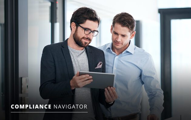 Two men in an office setting are looking at a tablet together. One wears glasses and a blazer, while the other is in a light blue shirt. Text on the image reads "Compliance Navigator.