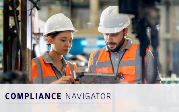 Two workers in safety gear and orange vests review information on a tablet in an industrial setting, utilizing workforce absence software. Text reads "Compliance Navigator.