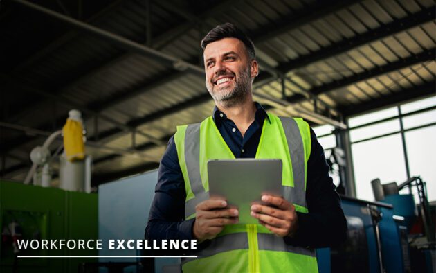 A man in a high-visibility vest holds a tablet while standing in an industrial setting. The text reads "Workforce Excellence.