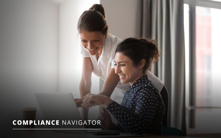 Two women smiling and looking at a laptop screen in an office setting. The text "COMPLIANCE NAVIGATOR" is in the bottom left corner.