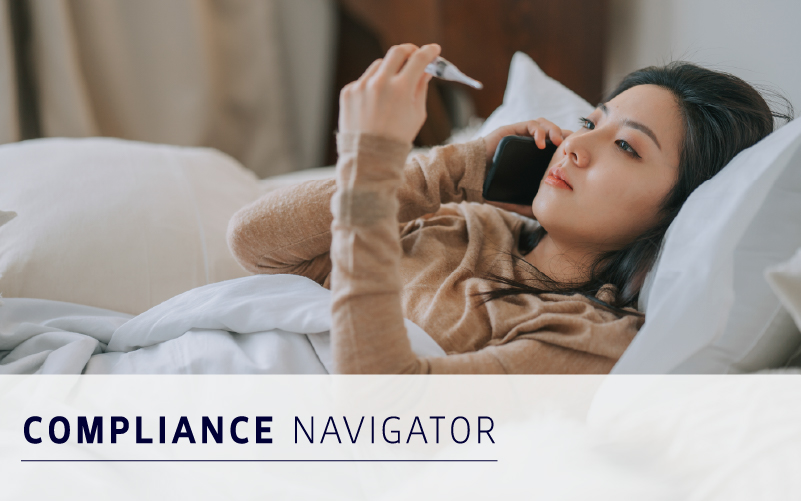 A woman lies in bed under a white blanket, holding a thermometer and talking on the phone. The text "COMPLIANCE NAVIGATOR" appears at the bottom, highlighting the benefits of workforce absence software.