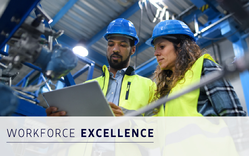 Two workers wearing hard hats and safety vests look at a tablet in an industrial setting, showcasing workforce management solutions. Text reads "Workforce Excellence.