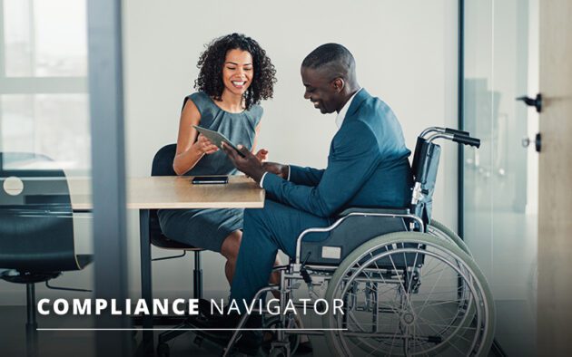Two professionals, one in a wheelchair, discussing documents at an office table with the text "Compliance Navigator" displayed.