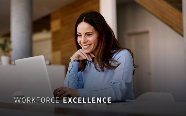 A woman in a blue shirt sits at a desk, smiling at her laptop; the text "Workforce Excellence" appears at the bottom of the image.