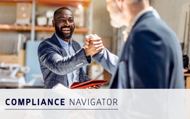 Two men in business attire shake hands and smile in an office setting. Text overlay reads "COMPLIANCE NAVIGATOR.