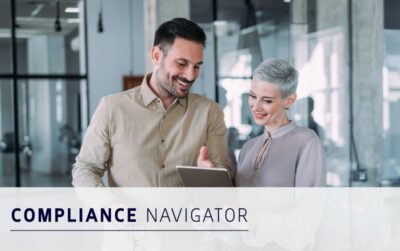A man and a woman standing together in an office, looking at a tablet. The text on the image reads "Compliance Navigator.