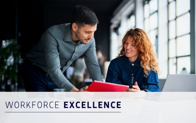 Two colleagues review documents together at a desk in a modern office. Text on the image reads "Workforce Excellence.