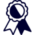 A simple, dark blue and white icon of an award ribbon with a circular rosette and two hanging tails.