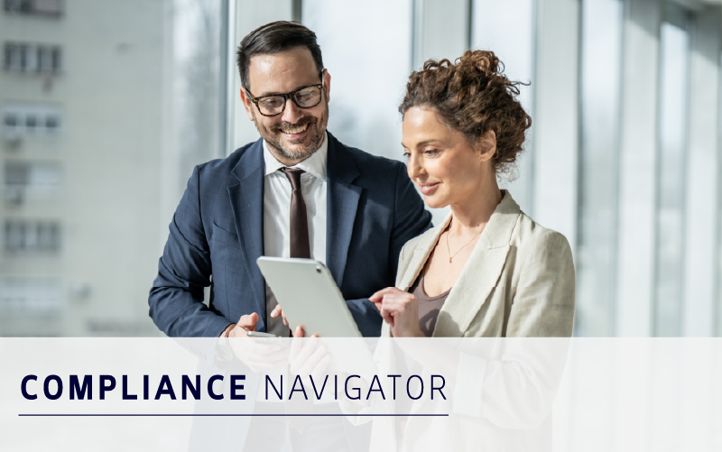 Two professionals in business attire stand by a window, looking at a tablet together. The text "COMPLIANCE NAVIGATOR" is displayed at the bottom of the image.