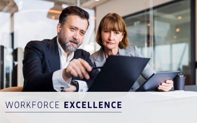 Two business professionals review a laptop together at a modern office table. The words "Workforce Excellence" appear at the bottom of the image.