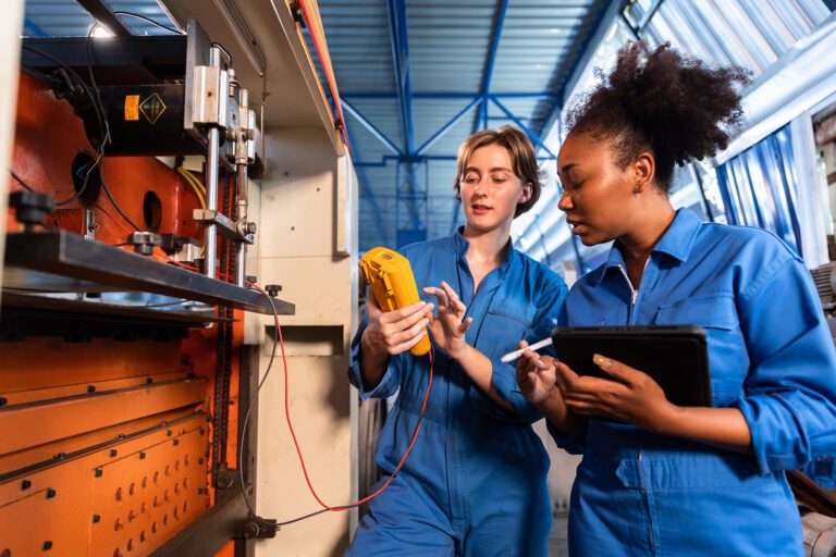 two women working on a server closet